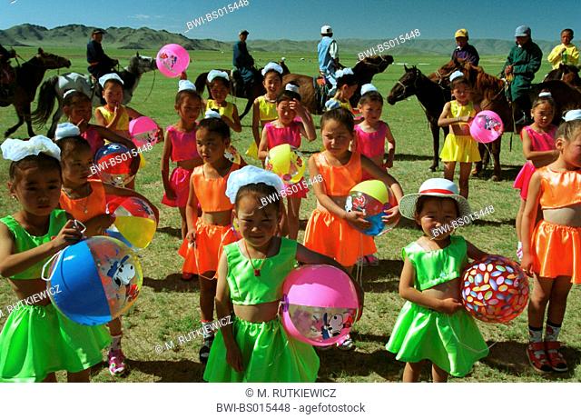 traditional Nadaam festival, or eriyn gurvan nadaam, the annual sports festival in Mongolia, colourful dressed girls during opening ceremony