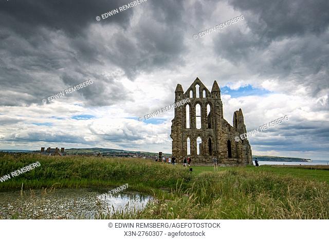 UK, England, Yorkshire - tourists enjoy the site of the Whitby Abbey located in England