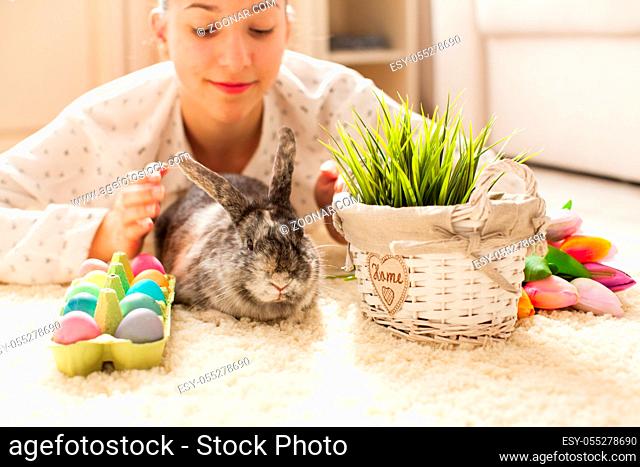 Easter rabbit in home with eggs and green grass