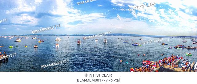 Panoramic view of boats floating on urban harbor