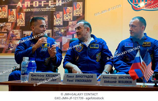 Expedition 35 NASA Flight Engineer Chris Cassidy, left, Soyuz Commander Pavel Vinogradov, center, and Russian Flight Engineer Alexander Misurkin are seen behind...