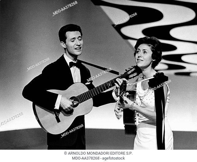 Caterina Valente with her brother Silvio. Italian singer, actress and showgirl Caterina Valente singing and playing guitar with her brother Silvio