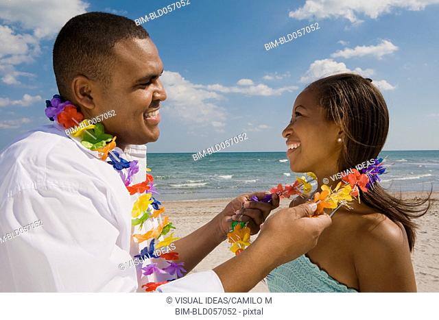 African couple wearing leis