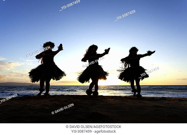 Three hula dancers at sunset at Wailea, Maui, Hawaii