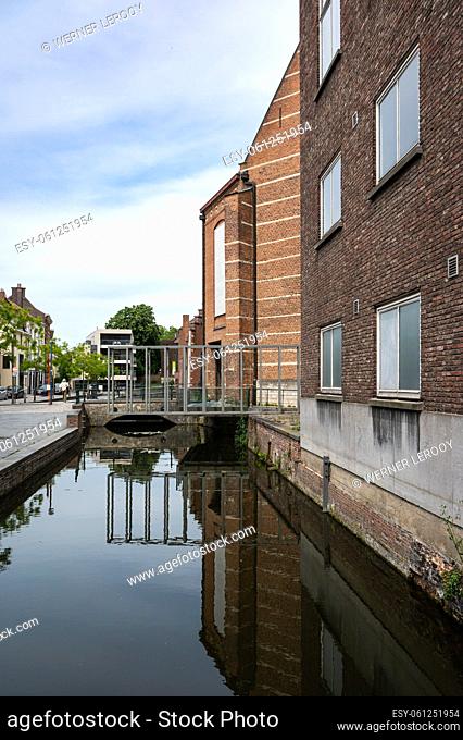 Mechelen, Antwerp Province, Belgium - 06 04 2022 - The residential complex called cells Almshouses, reflecting in the river Dyle