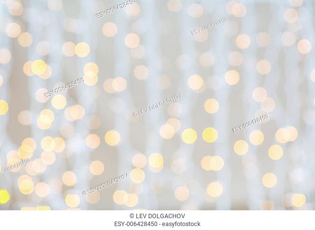 holidays, party and celebration concept - blurred glden lights background