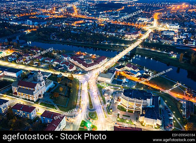 Grodno, Belarus. Night Aerial Bird's-eye View Of Hrodna Cityscape Skyline. Famous Historic Landmarks In Night Lightning. Catholic Church Of Discovery Of Holy...