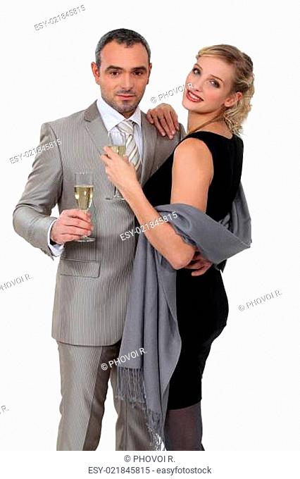 Elegant couple celebrating with champagne
