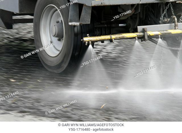 road sweeping truck cleaning dirty street
