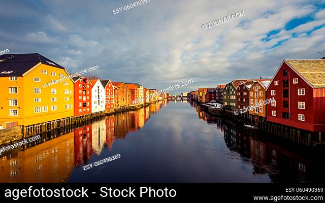 Old historic storehouses along the river Nidelva with colorful painted facades in Trondheim on beautiful winter day