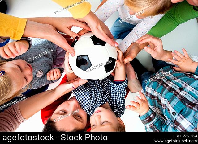 The group of little kids quarrel over a ball. Children in hysterics, because one boy intercepted the ball from others. The concept of children who are taught to...