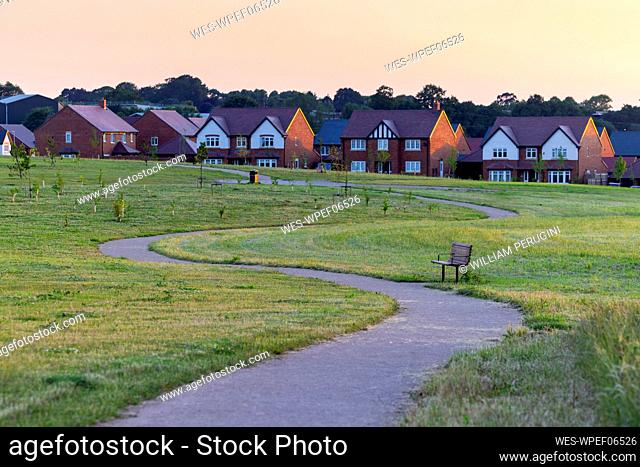 Winding road by detached houses in town