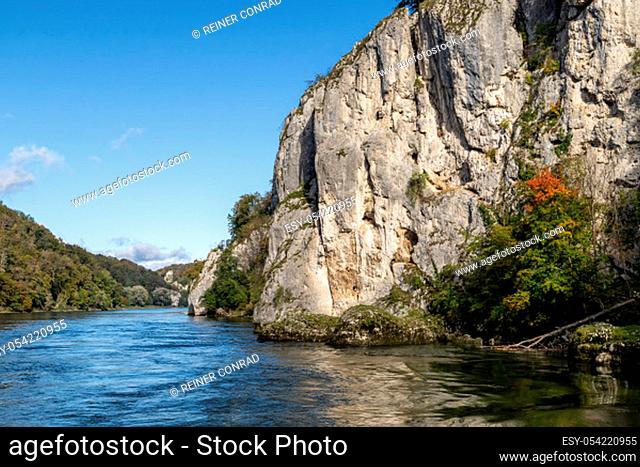 Danube river near Danube breakthrough near Kelheim, Bavaria, Germany in autumn with limestone rock formations and sunny weather with blue sky