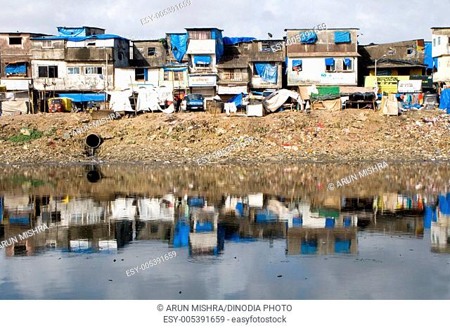 Bharat Nagar slum reflected in mithi river , Bandra , Bombay Mumbai , Maharashtra , India