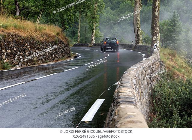 A car in a wet and small road after the rain, Souanyas, Pyrénées-Orientales, France, Europe