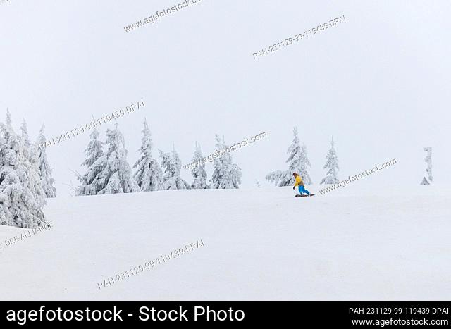 29 November 2023, Baden-Württemberg, Seebach: A winter sports enthusiast rides down a slope on a snowboard. The lift at Seibelseckle in the Ortenau district is...