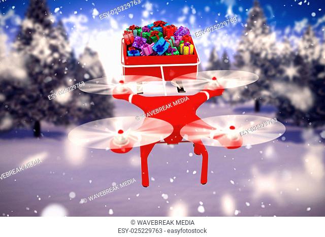 Composite image of high angle view of drone pulling chirstmas sledge