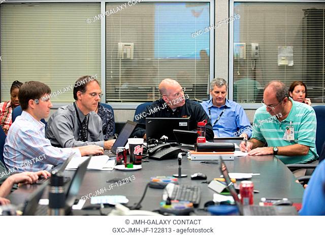 Four members of a joint operations panel for Expedition 35 are seen during a flight control team meeting on April 17 in a side room inside the NASA Johnson...