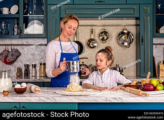 Happy loving mother and daughter girl prepare bakery. Home cooking