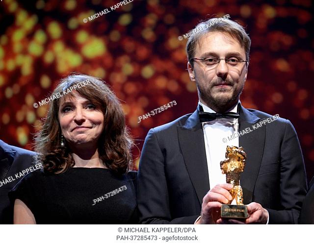 Director Calin Peter Netzer holds his Golden Bear for Best Film for the movie 'Child's Pose' ('Pozitia Copilului') next to Berlinale jury member Susanne Bier...