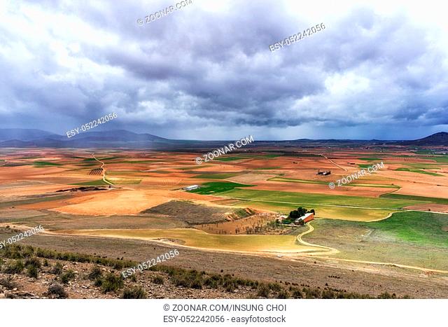 farmlands with stormy clouds above viewed from Windmills of Consuegra, Spain