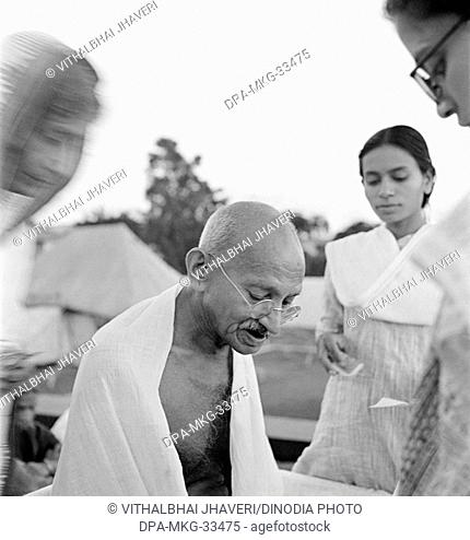 Mahatma Gandhi giving an autograph on his 75th birthday at Pune, Maharashtra, India, October 2, 1944 - MODEL RELEASE NOT AVAILABLE