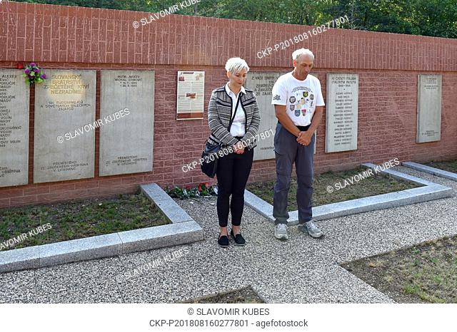 French writer Laurent Guillet (right) walked 2, 200 kilometres to the cemetery in Litvinov, where he laid flowers and lit candles in memory of victims of the...