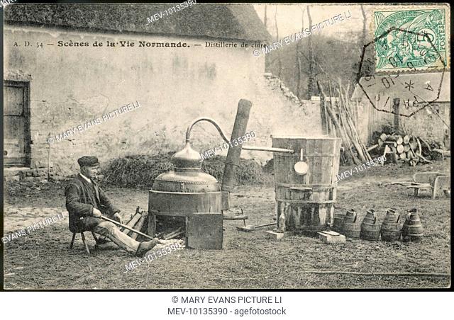 A local yokel sits beside  Calvados distillation equipment on a Normandy farm
