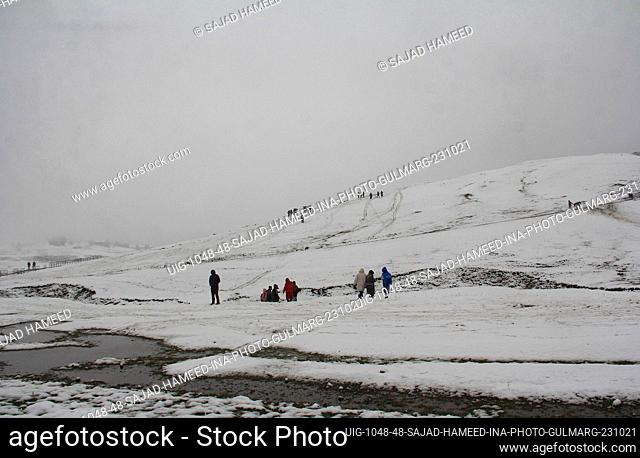 People enjoy the season's first snowfall in the world famous ski resort of Gulmarg on October 23, 2021 in Gulmarg, India