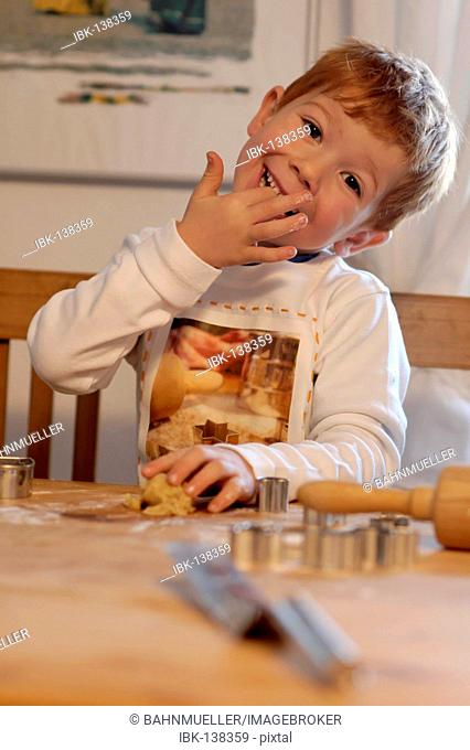 Boy baking cookies for christmas