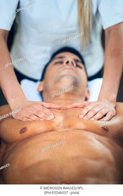 Sports massage. Physical therapist massaging man's chest