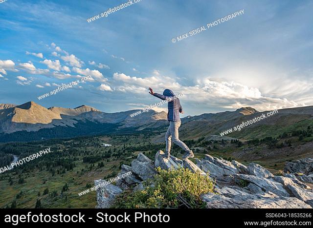 Woman hiking along rock formation ridge in Colorado Alpine