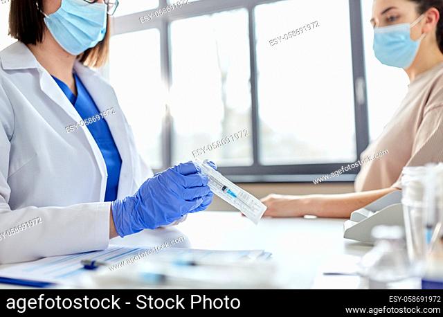 female doctor with syringe and patient at hospital