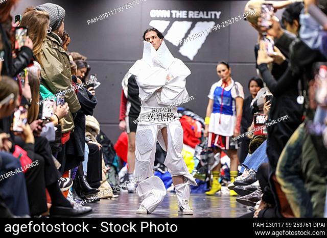 16 January 2023, Berlin: An activist walks the catwalk at a performance disguised as an Adidas show during Berlin Fashion Week