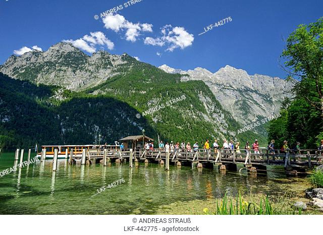 People leaving boat and walking on landing stage, Salet, lake Koenigssee, Berchtesgaden range, National Park Berchtesgaden, Berchtesgaden, Upper Bavaria