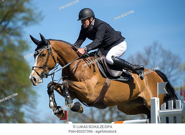 Rider Roger Yves Bost of France and his horse Sangria du Coty jump over a hurdle during the Mercedes Benz Championat Derby Tournament qualification for the...