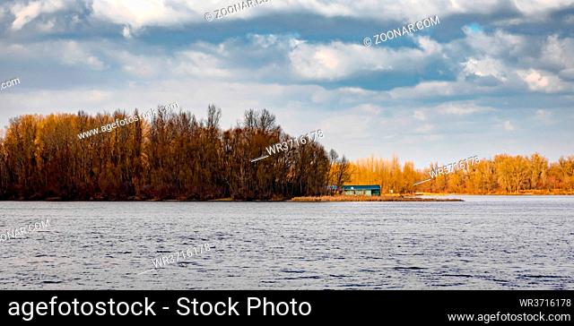 Little house close to the Dnieper river in Kiev, Ukraine, at the beginning of spring, under a cloudy sky