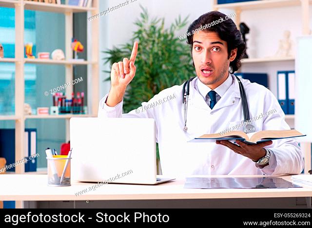 Young handsome doctor working in clinic