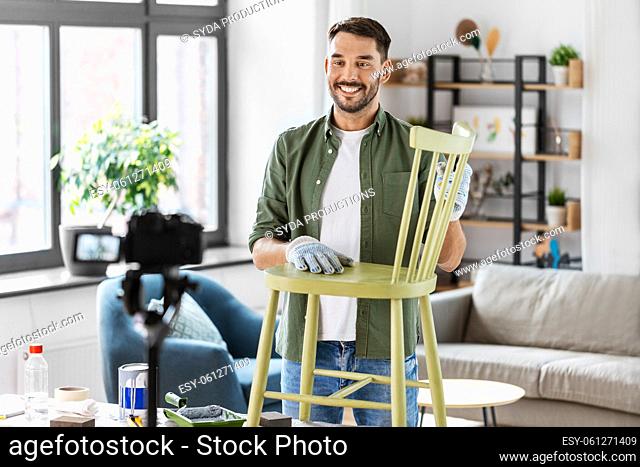 man or blogger showing old chair renovation