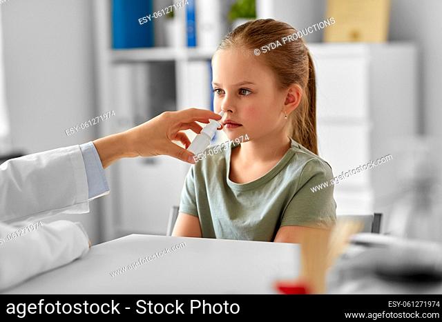 doctor with nasal spray and girl patient at clinic
