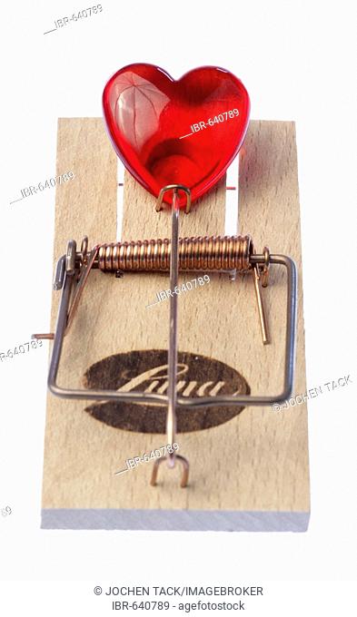 Symbolic shot: heart caught in a mousetrap, love trap