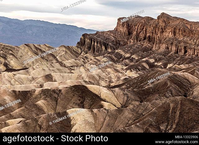 A picturesque desert-Scene with heavily eroded Ridges taken at the well-known Zabriskie Point, Death Valley National Park, California, USA