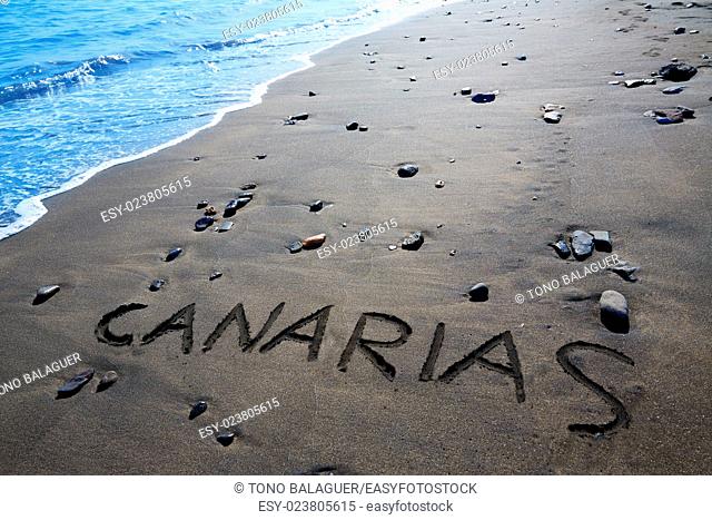 Canarias word written spell in black sand beach Canary Islands of Spain