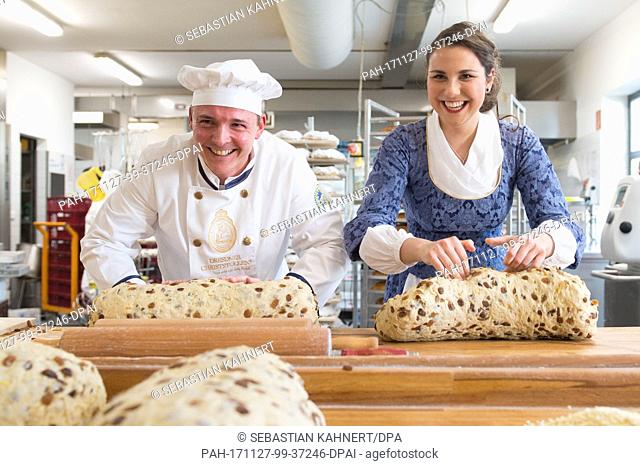 The 23rd Dreden Stollenmaedchen (lit. stollen bread girl) Hanna Haubold and master baker Andreas Wippler bake a giant stollen in the bakery Wippler inÂ Dresden