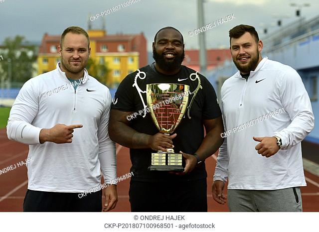 (L-R) Third placed Tomas Stanek of Czech Republic, winner Darrel Hill of USA and second placed Konrad Bukowiecki of Poland pose after the men's shot put...