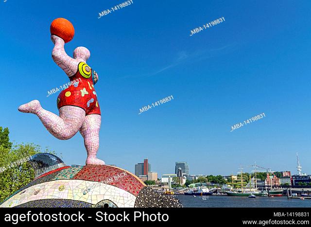 Sculpture by Niki de Saint Phalle in front of the Stage Theater in the harbor on the Musical Boulevard with a view over the Elbe to St
