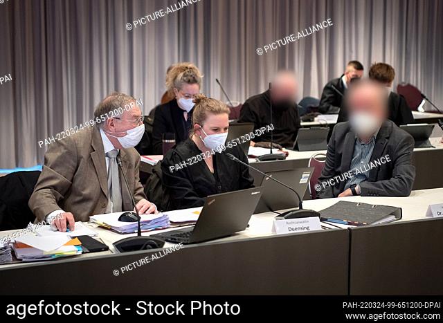 24 March 2022, Lower Saxony, Oldenburg: Two defendants (r, 2nd from right) sit before the start of the trial against ex-superiors of the convicted former nurse...