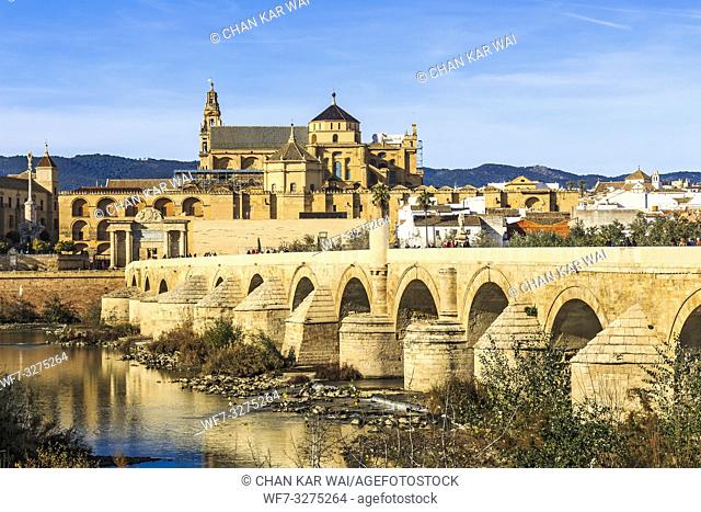 Cordoba, Spain - Dec 2018: Picturesque view of the Roman bridge of Cordoba facing Mosque-Cathedral of Cordoba