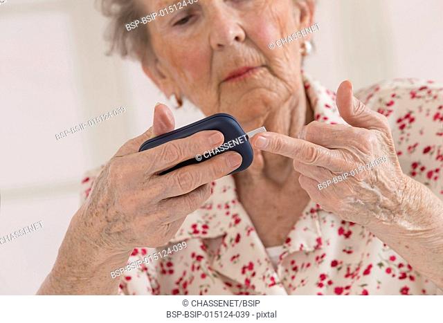 Senior woman checking her blood glucose level