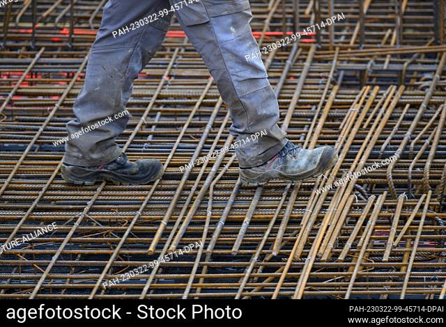 22 March 2023, Saxony, Dresden: A construction worker walks along a reinforced concrete ceiling at the building site of the extension to the headquarters of...